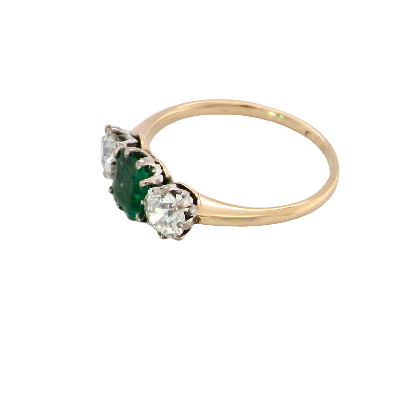 side A vintage trilogy ring. Centre stone a step cut emerald, 6.5x5.5mm (est .75 carats). The emerald is dark green.
