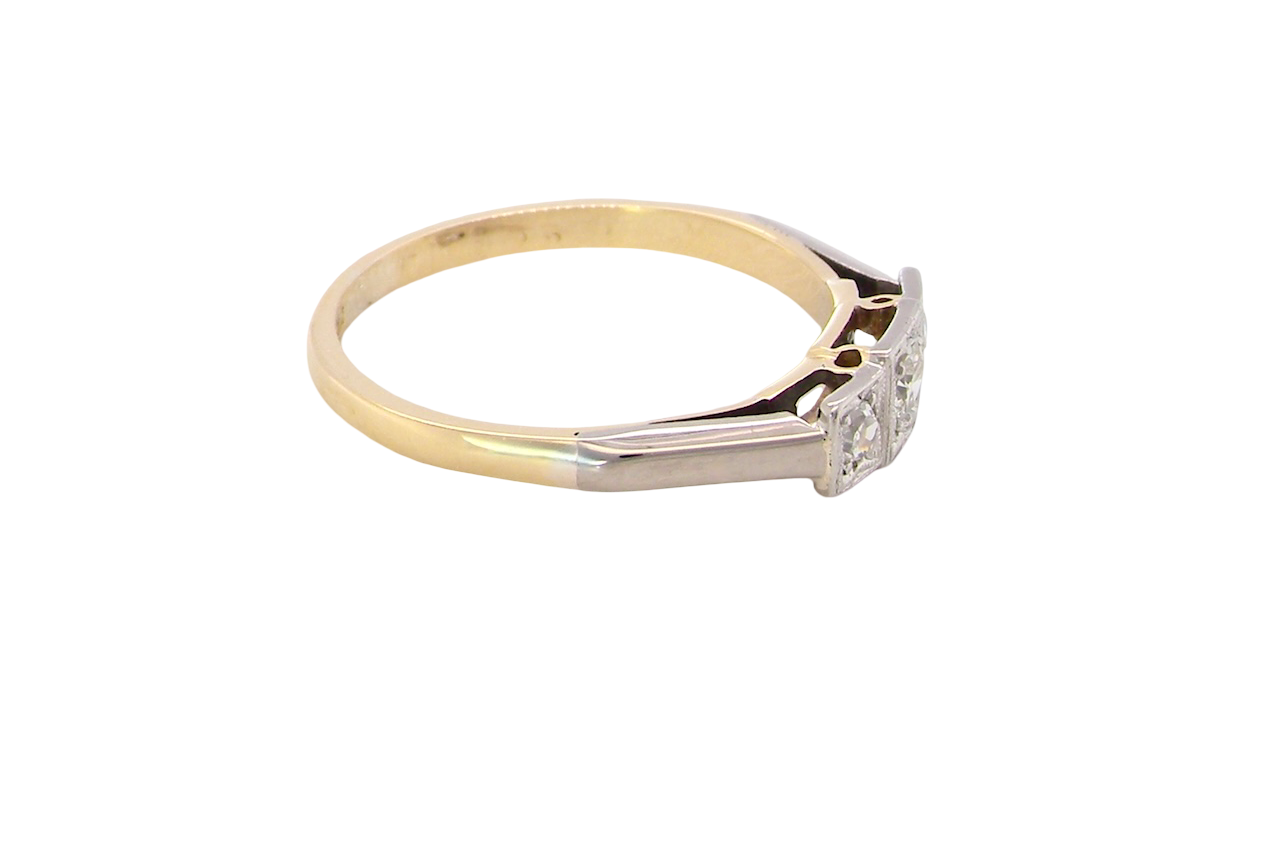 side A vintage trilogy ring. Set with three old brilliant cut white diamonds, centre 3mm and each side a 2.4mm diamond. Total estimated at 0.20 carats, colour H-j, clarity Si