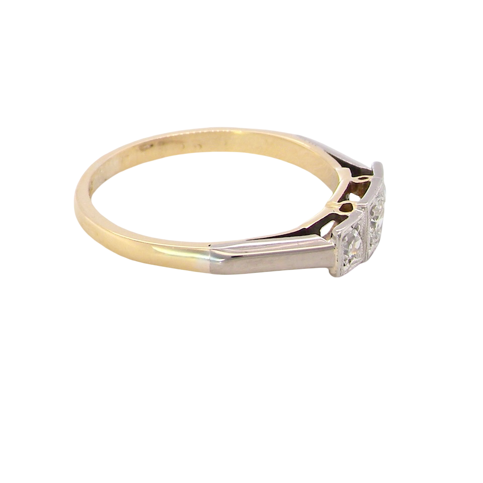 side A vintage trilogy ring. Set with three old brilliant cut white diamonds, centre 3mm and each side a 2.4mm diamond. Total estimated at 0.20 carats, colour H-j, clarity Si