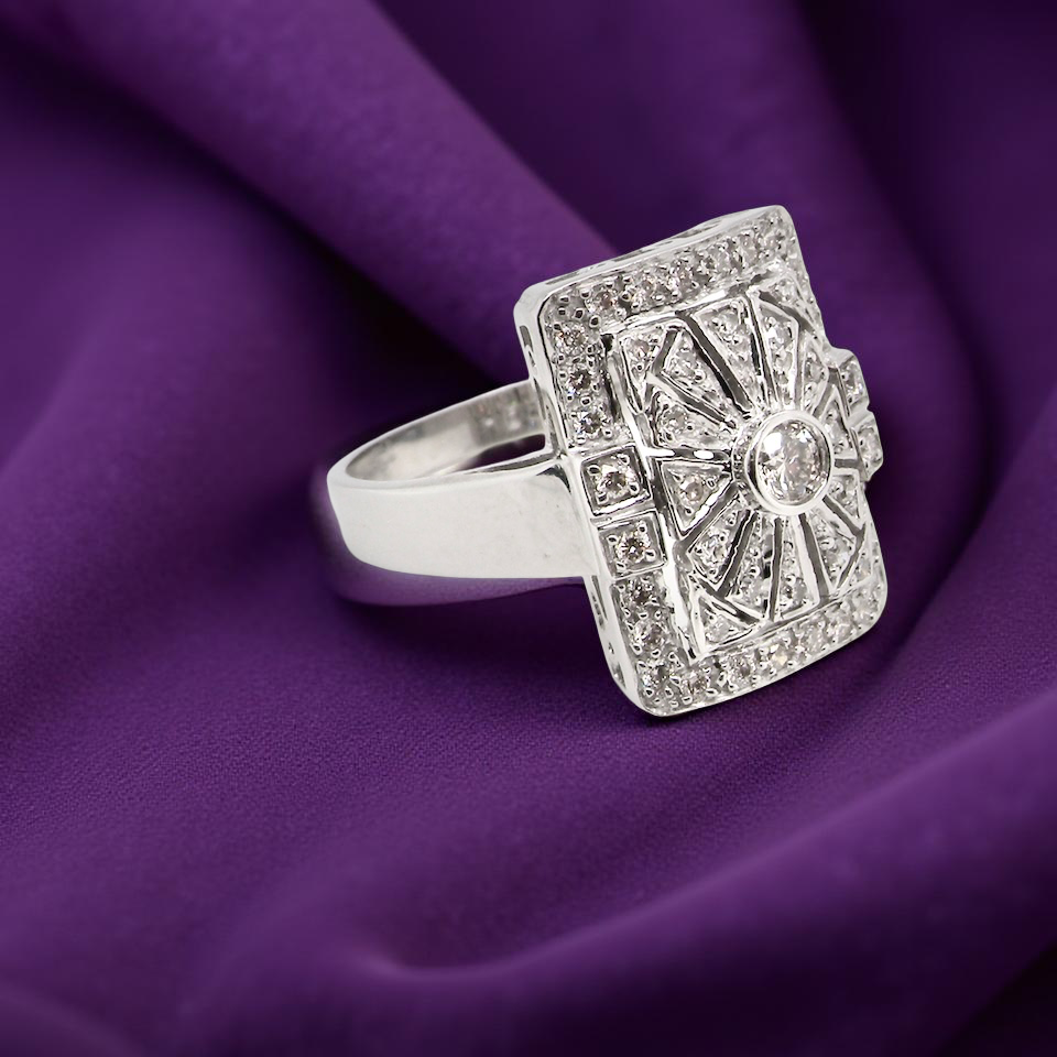 ring with gemstones on a purple fabric background