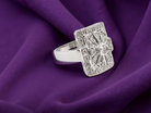 ring with gemstones on a purple fabric background