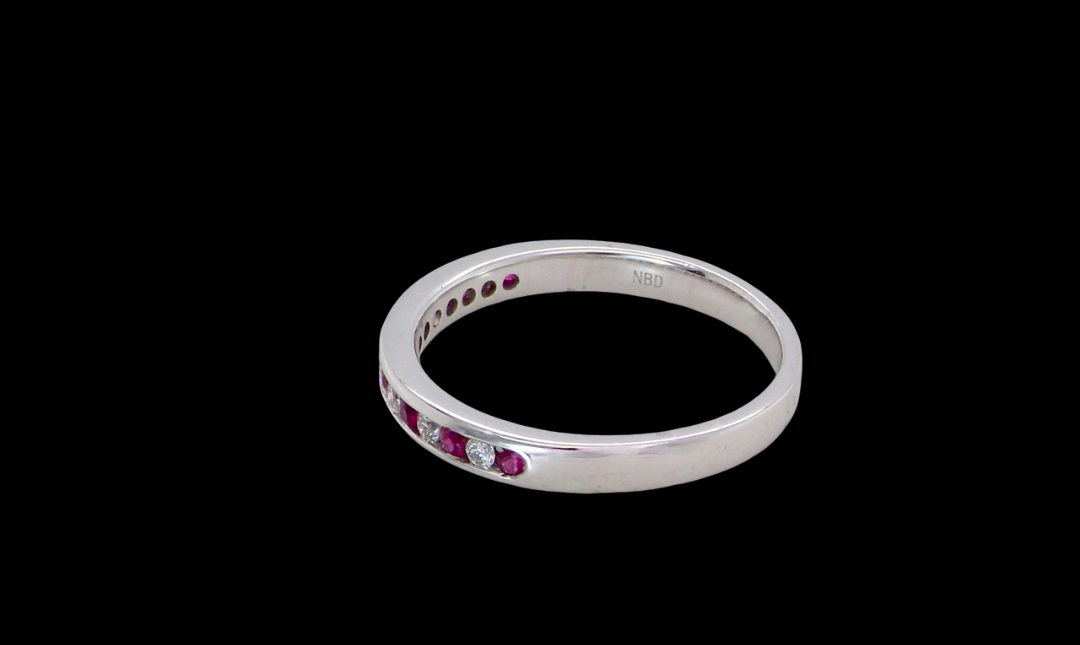 side A white gold half hoop eternity ring. Set with seven round rubies and six brilliant cut white diamonds
