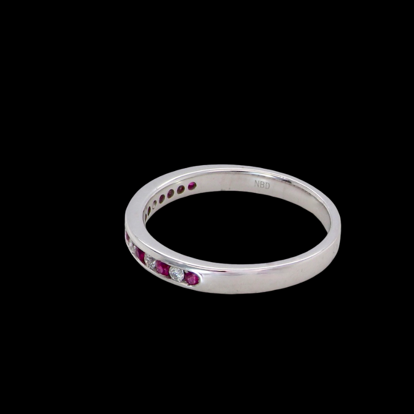 side A white gold half hoop eternity ring. Set with seven round rubies and six brilliant cut white diamonds