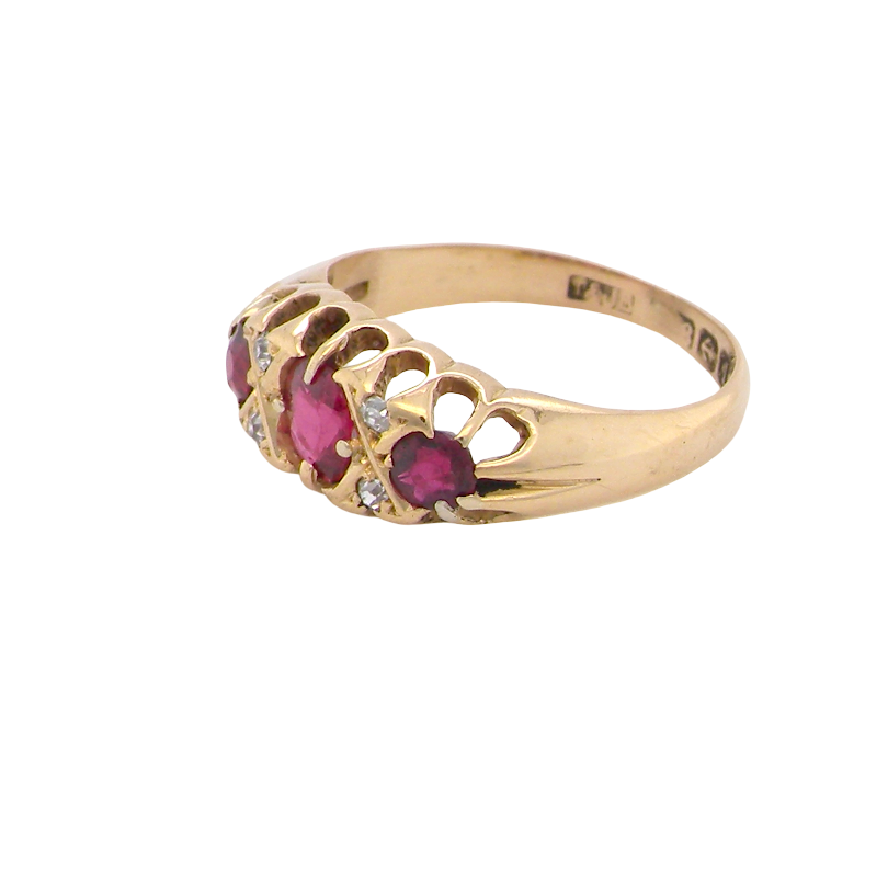side An 18 carat gold antique boat shaped ring. Features three lovely coloured wine red rubies, centre 5x4mm, each end 2.4mm.