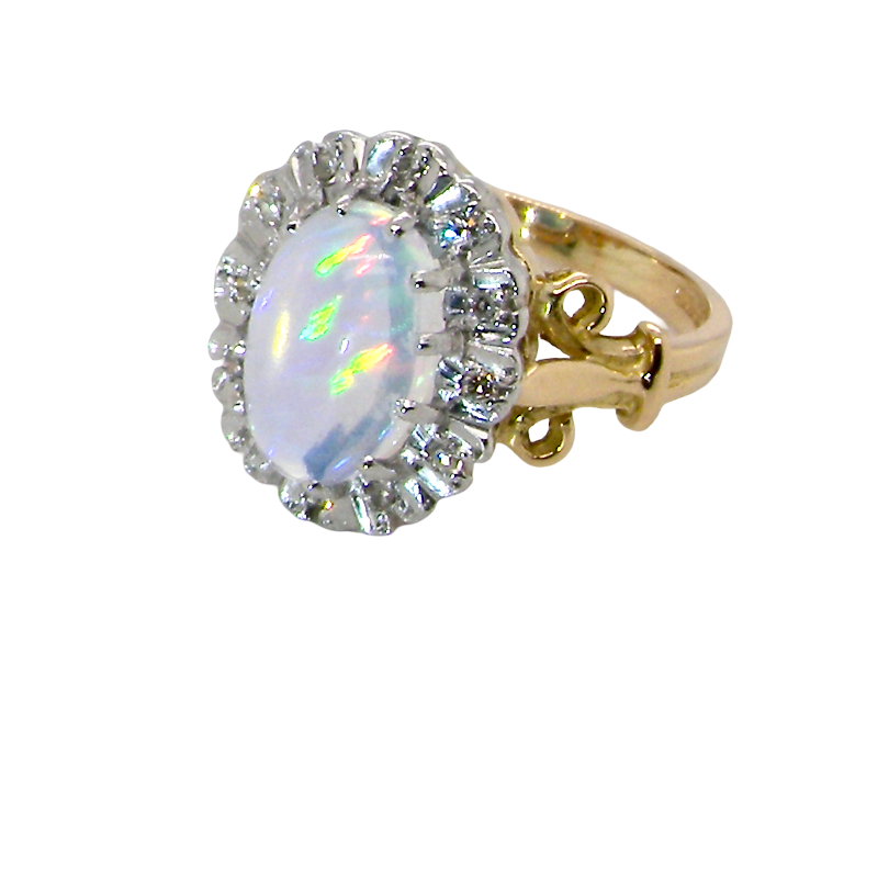 side An 18 carat gold cluster ring. Features an oval opal centre stone with excellent play of colour with a predominance of watery purple and flashes of orange, and luminous green.
Measures 11x7mm.