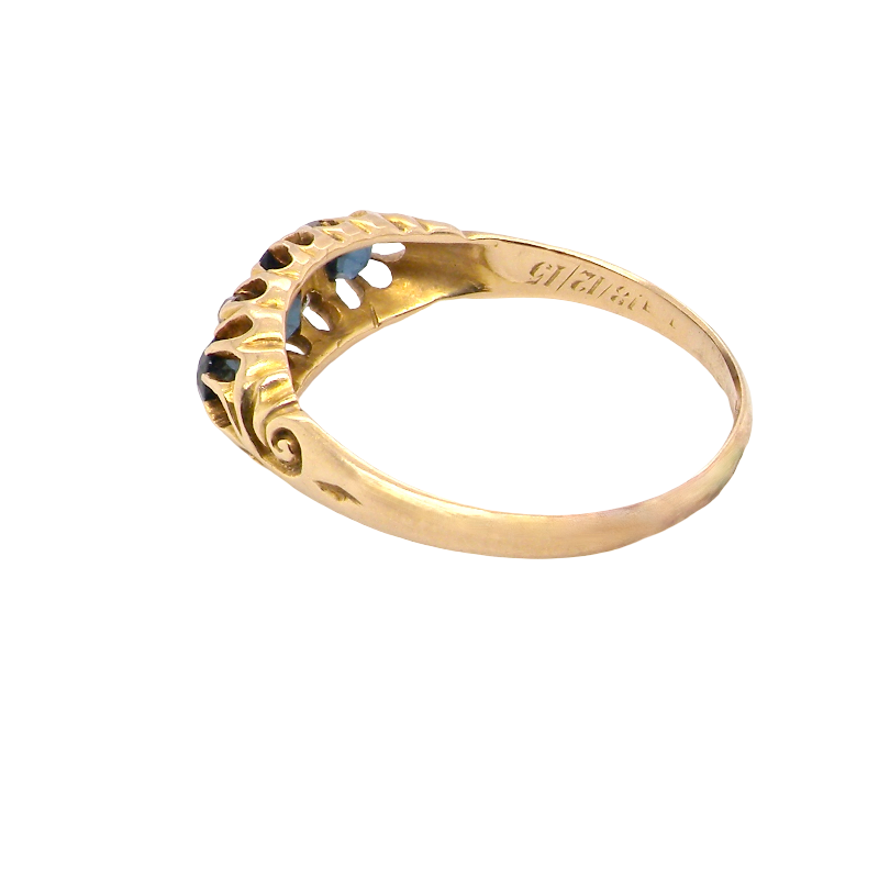 side An 18 carat gold early 20th century ring set with three sapphires. Centre 5x3.8mm each end 3.8x2.8mm.