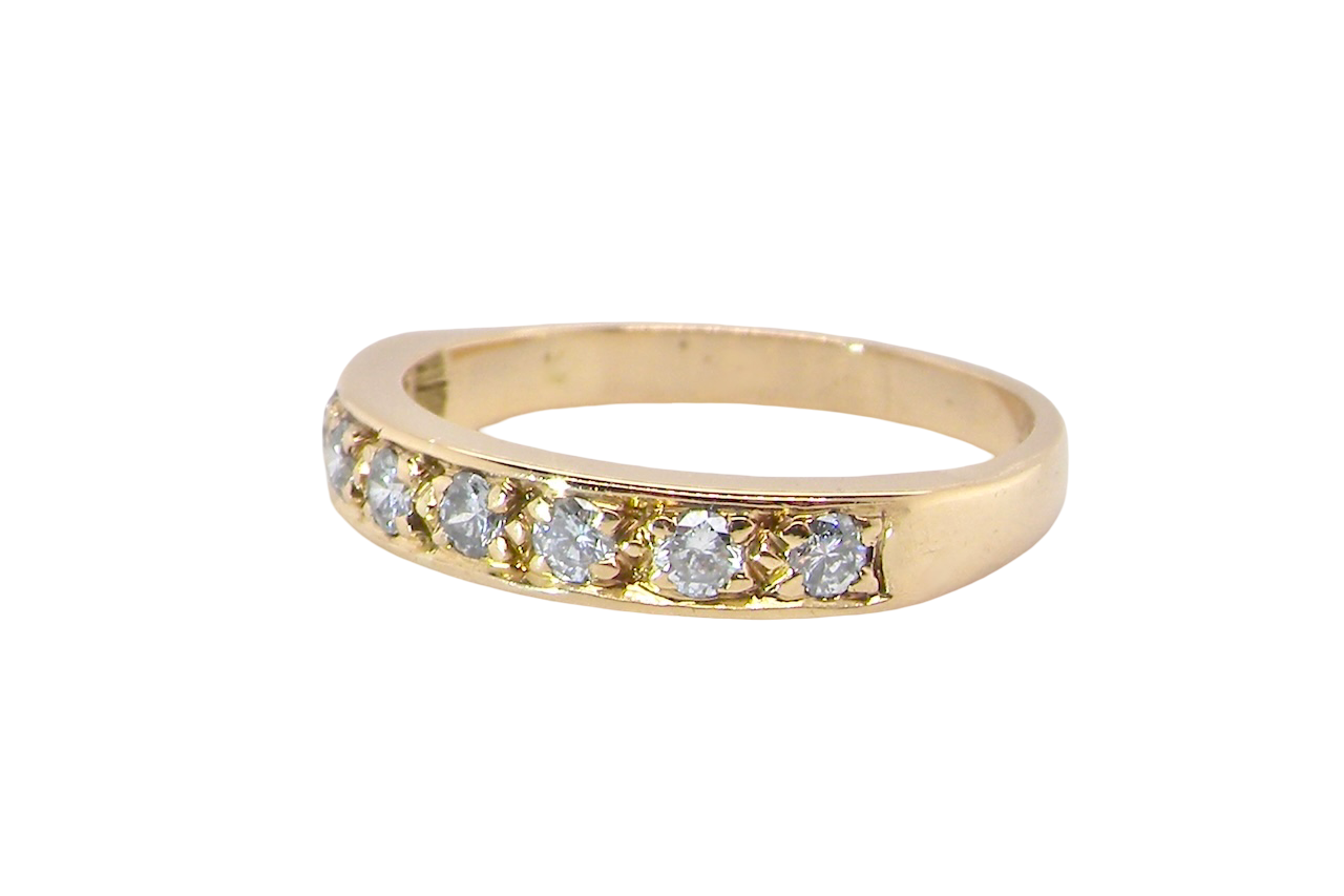 side An 18 carat gold half-hoop eternity ring, set with eight brilliant-cut white diamonds