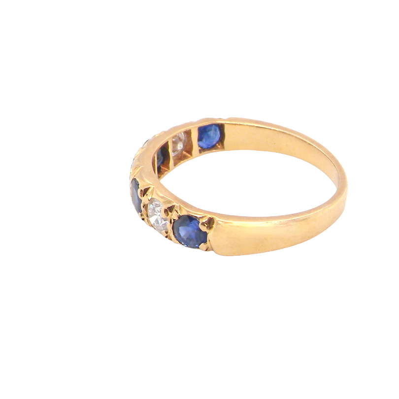 side An 18 carat gold half hoop eternity ring. Set with four sapphires each 3.4mm (0.15 carats) and three diamonds, brilliant cut, 3.4mm (0.15 carats).