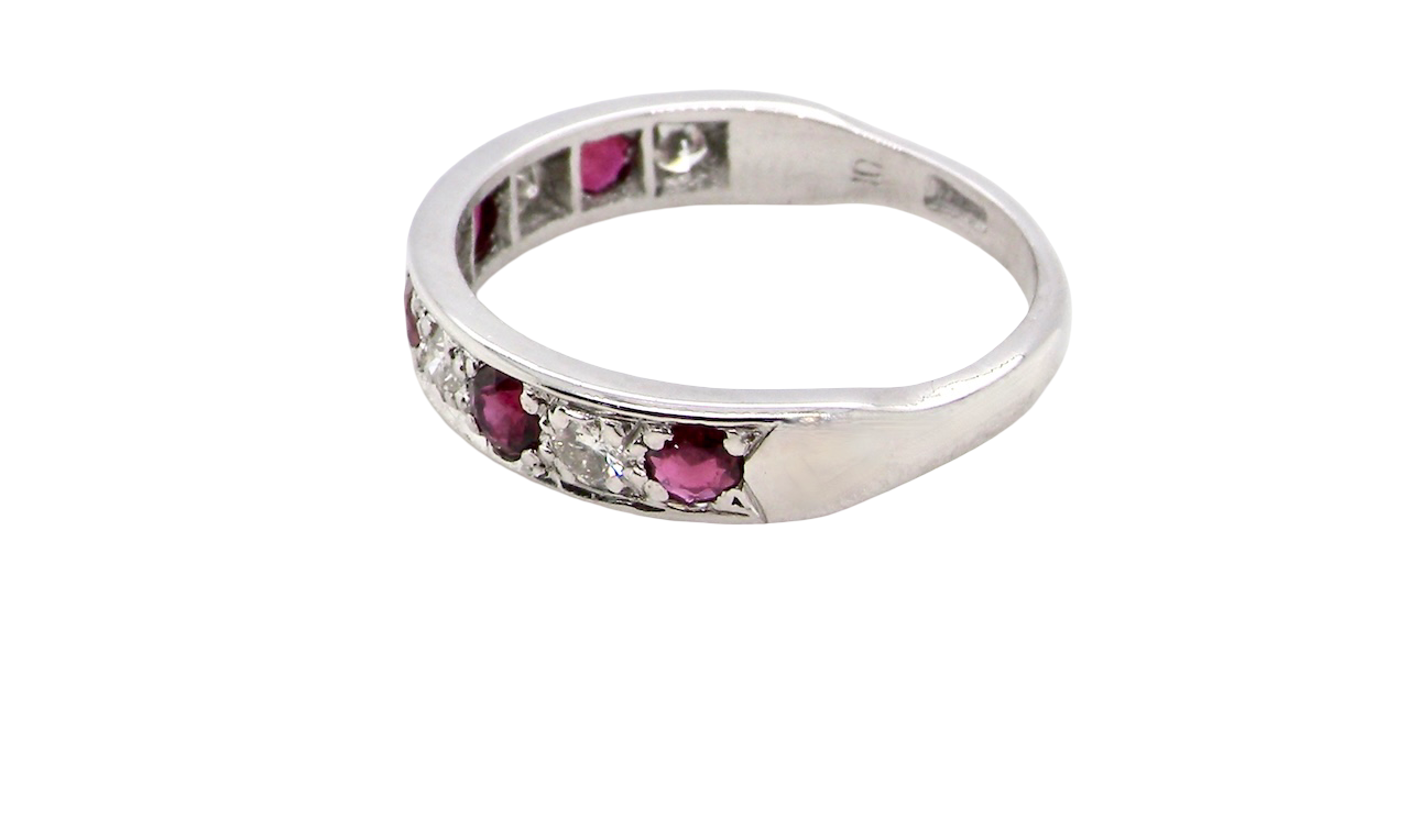 side An 18 carat white gold half hoop eternity ring. Set with five round 3mm rubies (est 0.50 carats) 