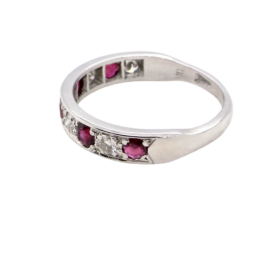 side An 18 carat white gold half hoop eternity ring. Set with five round 3mm rubies (est 0.50 carats) 