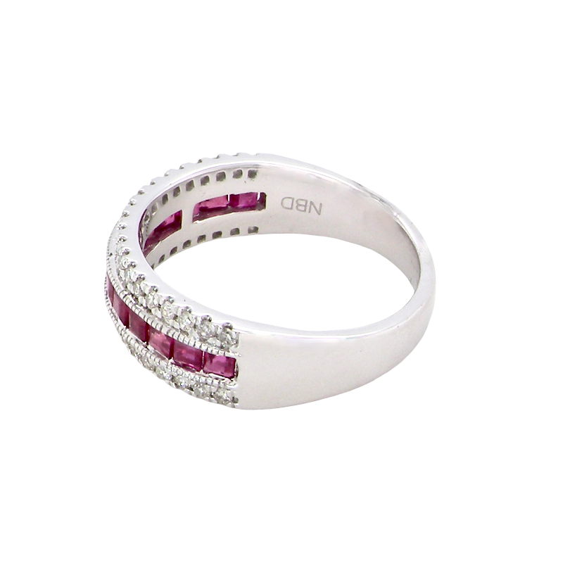 side An 18 carat white gold half hoop ring. A triple row design with a line of channel set calibre cut rubies running along the centre , to a total carat weight of 0.97 carats.