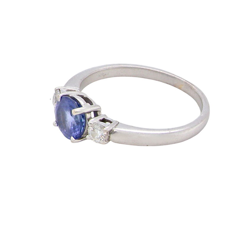 side An 18 carat white gold three stone ring. Centre stone a round tanzanite 6mm diameter.
Each side a brilliant cut white diamond