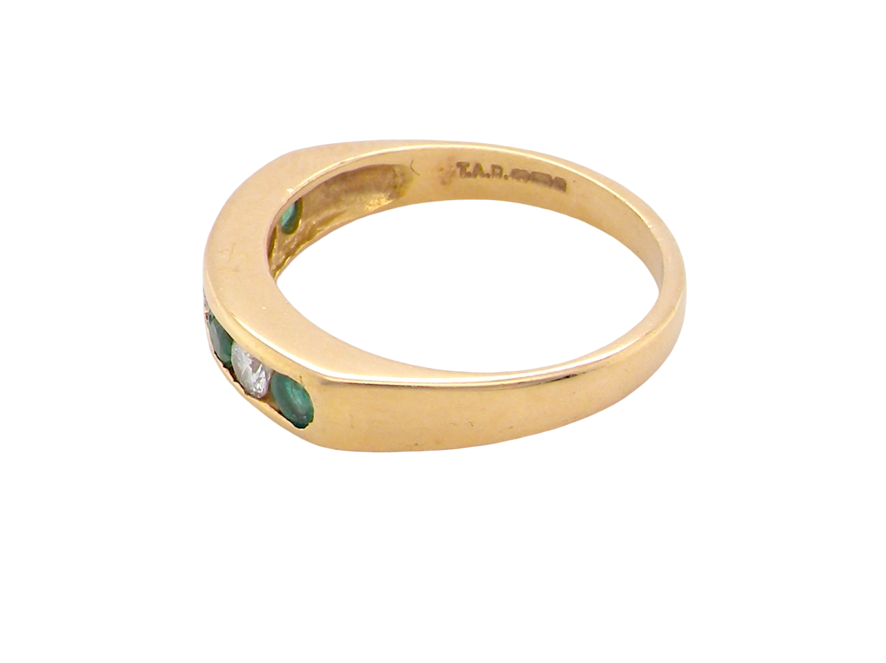side An 18 carat yellow gold half hoop eternity ring. Set with four round emeralds, each 3mm, and alternate set with brilliant cut white diamonds, each 3mm (total est 0.30 carats)