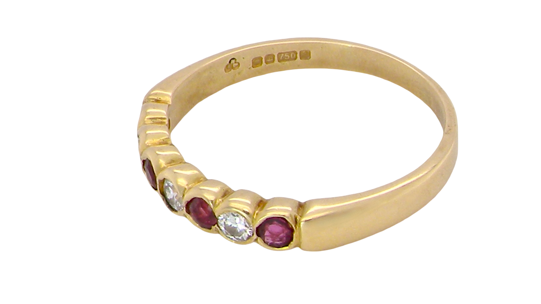 side An 18 carat yellow gold half hoop eternity ring. Set with four rubies, 3mm each.
Set with alternate diamonds, each 3mm (0.10 carats each) colour i-j, clarity Si.