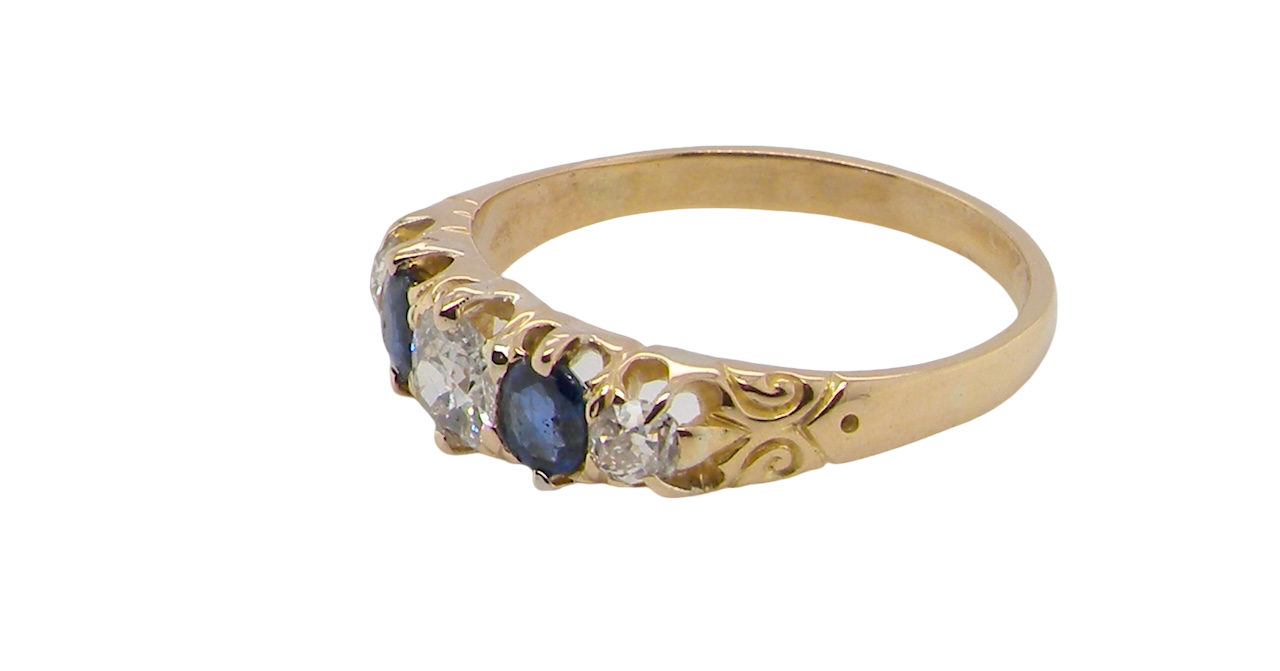 An antique ring from the early years of the 20th century. Centre stone 5mm diameter (0.50 carats) Colour H-j, clarity Si. Each side a mid colour blue sapphire 4mm diameter.
side view