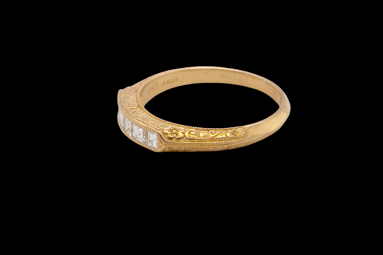 side An attractive half hoop diamond eternity ring. Set with six step cut white diamonds, that sit side by side, the colour estimated at H-i, clarity Si.