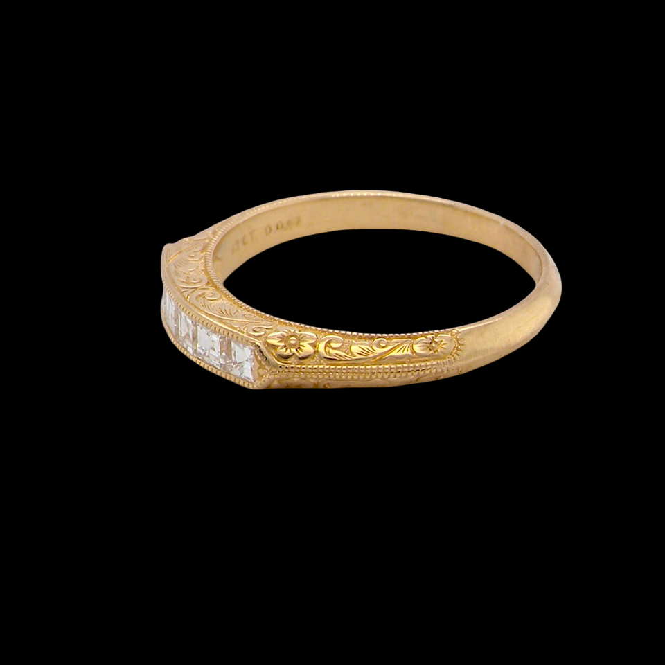 side An attractive half hoop diamond eternity ring. Set with six step cut white diamonds, that sit side by side, the colour estimated at H-i, clarity Si.