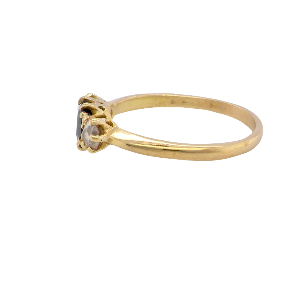 side An early 20th-century trilogy ring set with a mid to dark cornflower blue central sapphire,