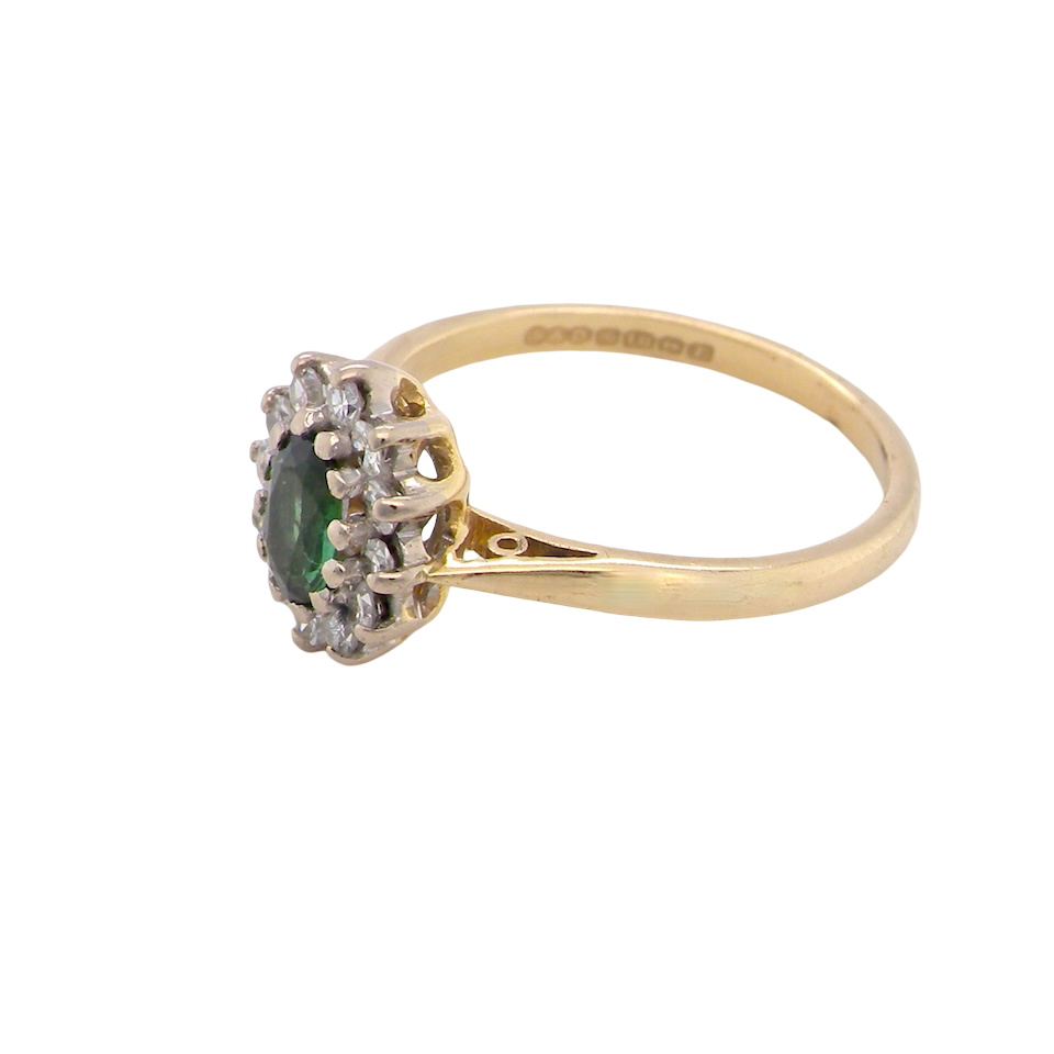 side An elegant 18 carat gold cluster ring featuring a beautifully proportioned 6 × 4mm green tourmaline