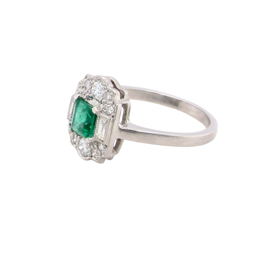 side An elegant Art Deco–style cluster ring of plaque design, centred with a square step-cut emerald measuring approximately 4.5 × 4.5 mm (estimated 0.40 carats). The emerald displays a vibrant, lively green colour and is beautifully framed by diamonds.