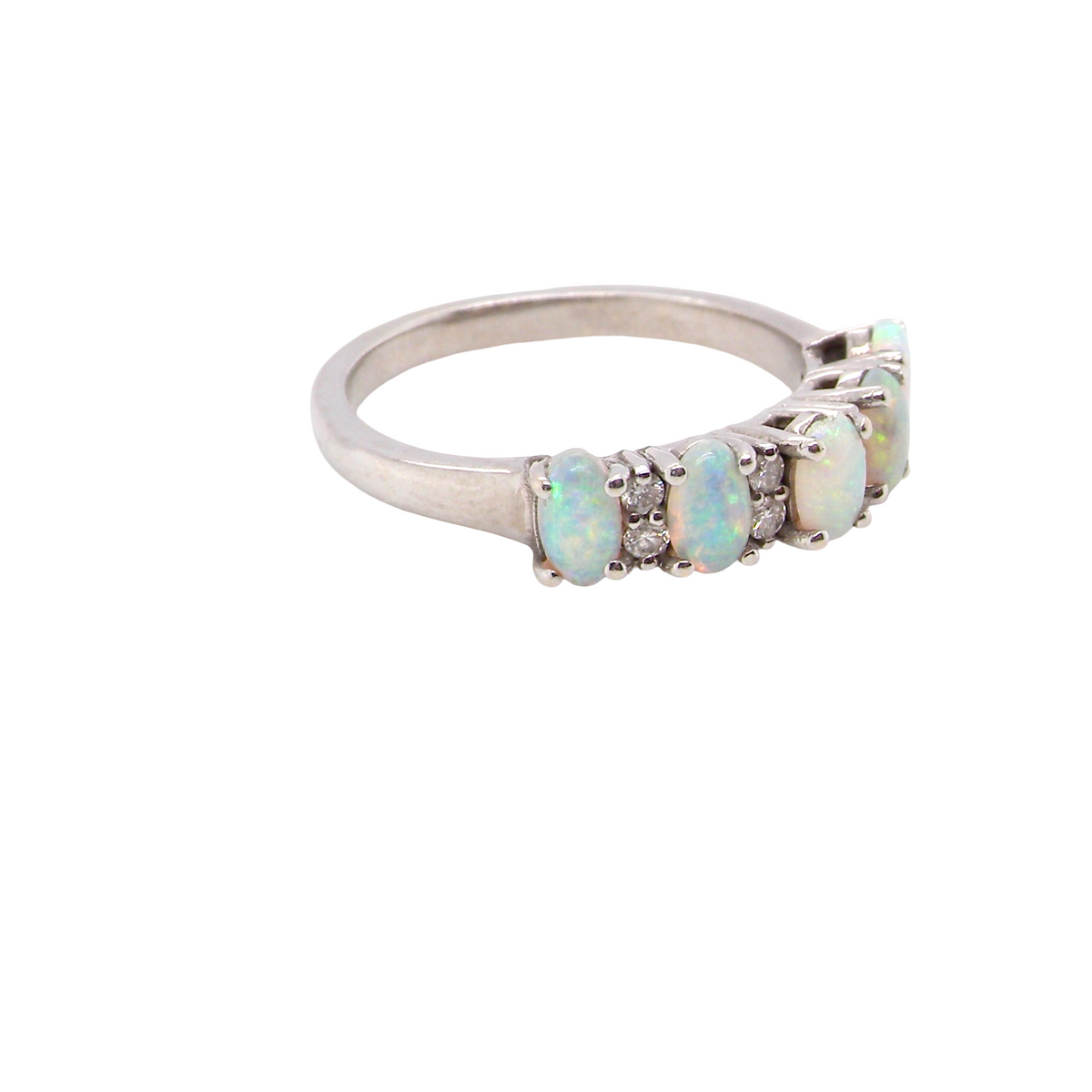 An elegant opal and diamond half hoop ring, featuring five oval opals with lively play of colour. Each opal measures 5 x 3mm, with an estimated total opal weight of approximately 0.75 carats, all claw set to maximise light and colour.