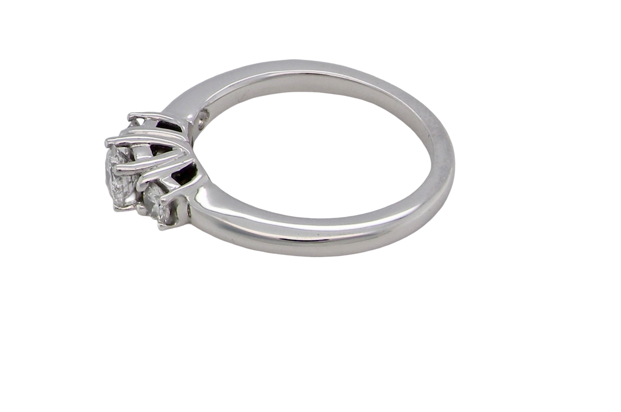 side An elegant trilogy ring set with three brilliant-cut white diamonds,
