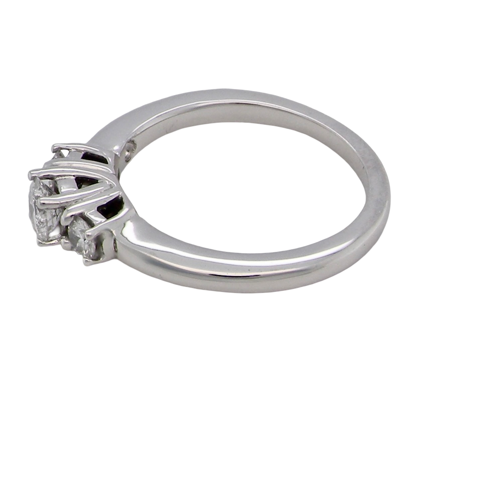 side An elegant trilogy ring set with three brilliant-cut white diamonds,