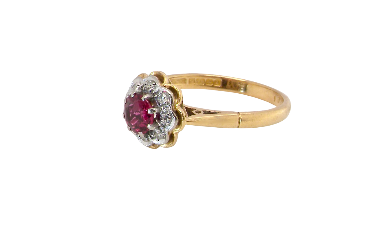 side An exquisite vintage cluster ring centred around a 5 mm ruby,( 0.50 carats)