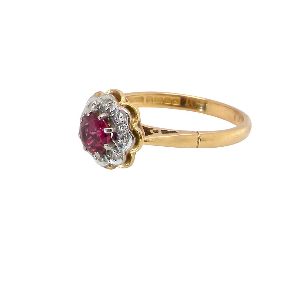 side An exquisite vintage cluster ring centred around a 5 mm ruby,( 0.50 carats)