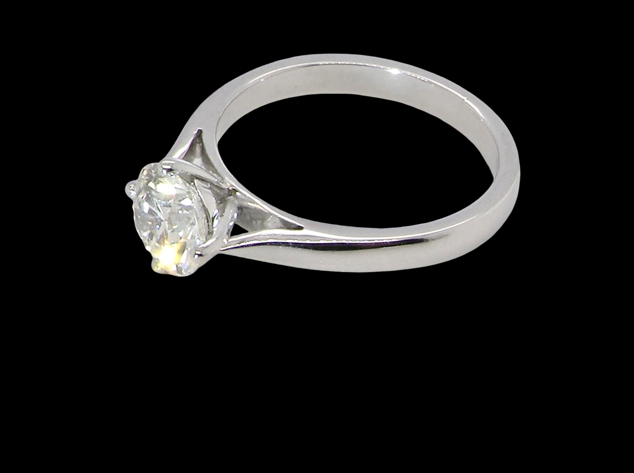 side An impressive platinum solitaire ring set with a modern brilliant-cut white diamond.