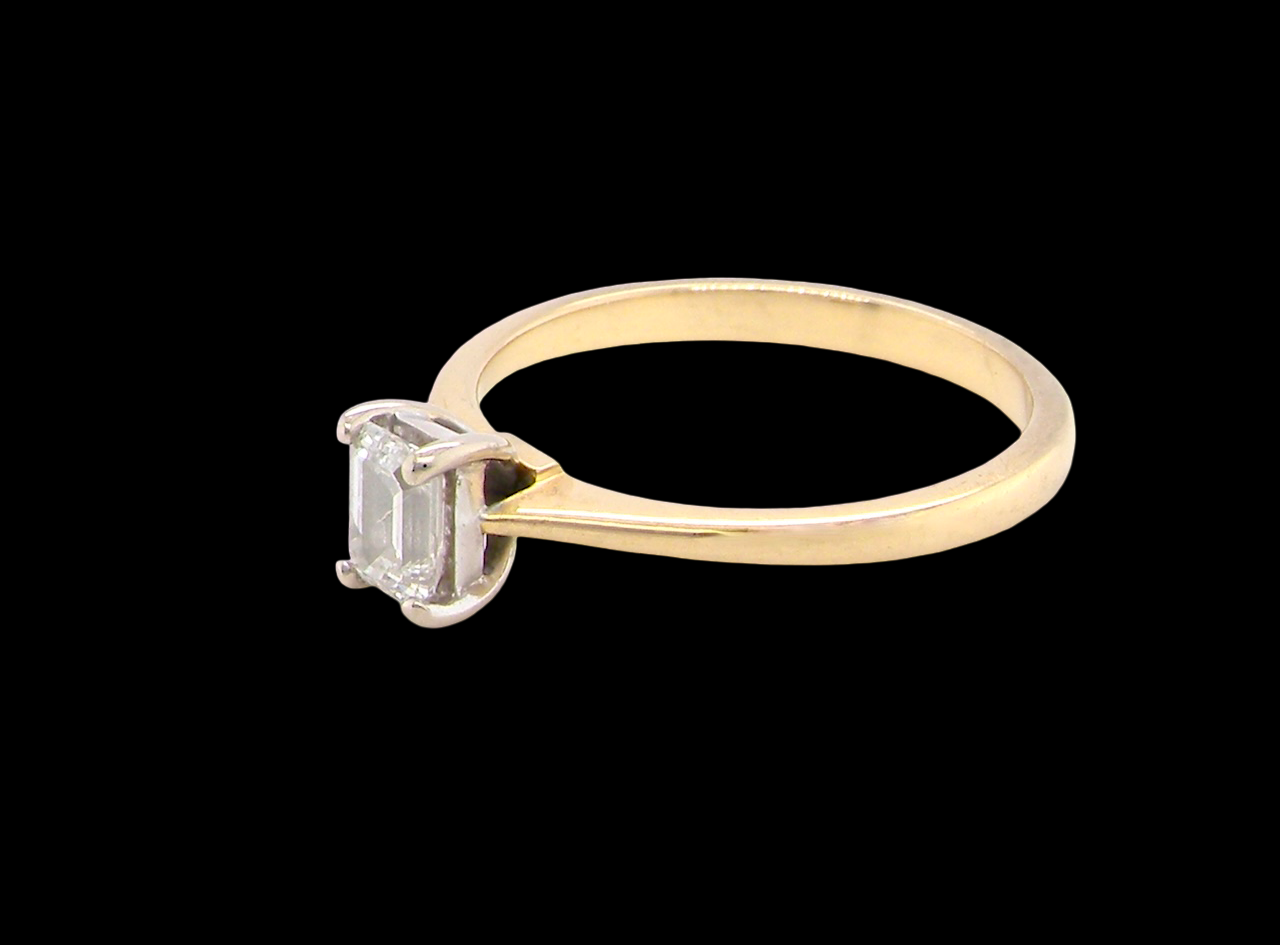 side Elegant and timeless, this solitaire ring features a beautifully cut emerald-cut diamond measuring 5 x 4mm, confirmed at approximately 0.40 carats. The diamond is graded J colour and VS clarity, offering excellent sparkle