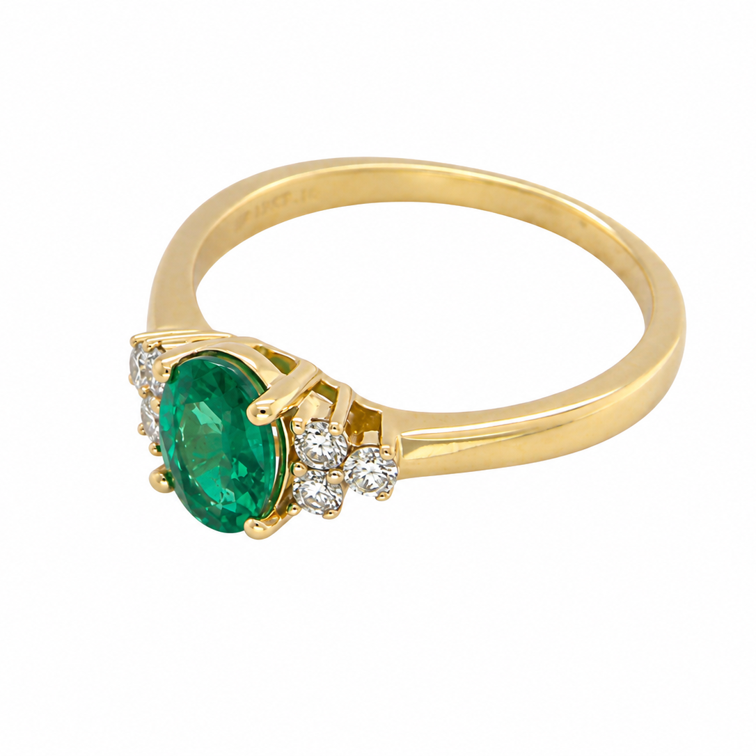 side Featuring a lovely deep velvety green emerald centre stone, this 18 carat gold ring is enhanced by six brilliant cut white diamonds.