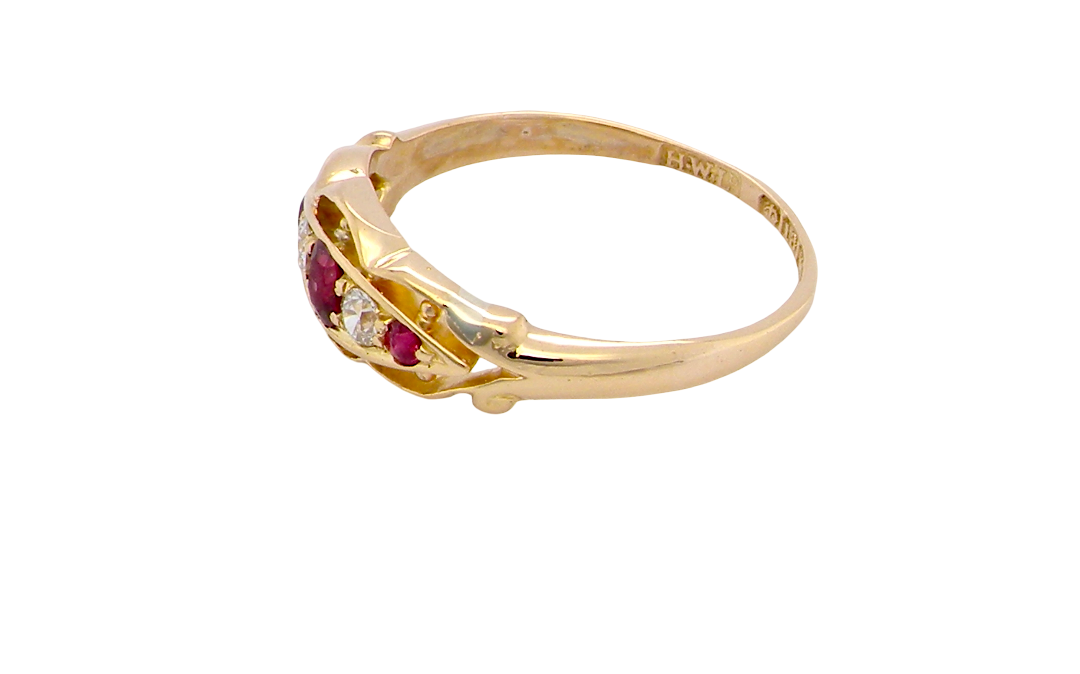 side Set with three bright rubies, centre 3x2.6mm, each end a 2mm ruby. Each side of the centre stone an old brilliant cut white diamond 2.8mm (est 0.08 carats) . Head measures 17x7mm, weight 3.4grams. 