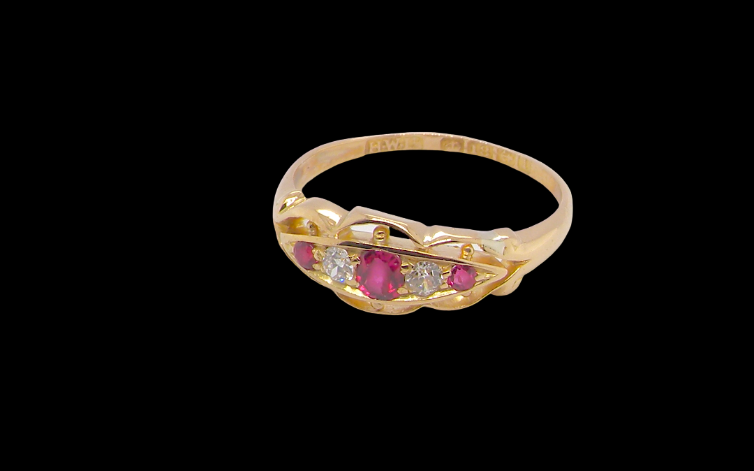 side Set with three bright rubies, centre 3x2.6mm, each end a 2mm ruby. Each side of the centre stone an old brilliant cut white diamond 2.8mm (est 0.08 carats) . Head measures 17x7mm, weight 3.4grams. 