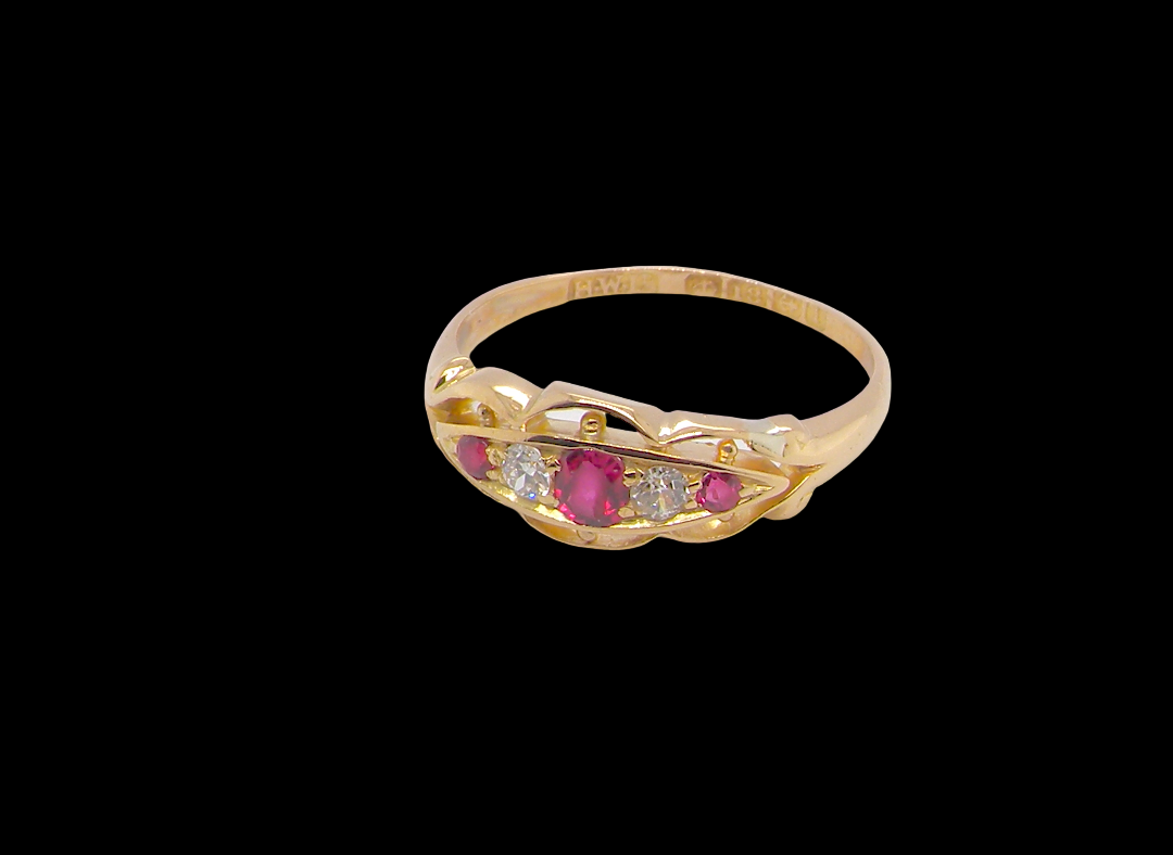 side Set with three bright rubies, centre 3x2.6mm, each end a 2mm ruby. Each side of the centre stone an old brilliant cut white diamond 2.8mm (est 0.08 carats) . Head measures 17x7mm, weight 3.4grams. 