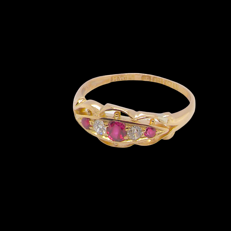 side Set with three bright rubies, centre 3x2.6mm, each end a 2mm ruby. Each side of the centre stone an old brilliant cut white diamond 2.8mm (est 0.08 carats) . Head measures 17x7mm, weight 3.4grams. 
