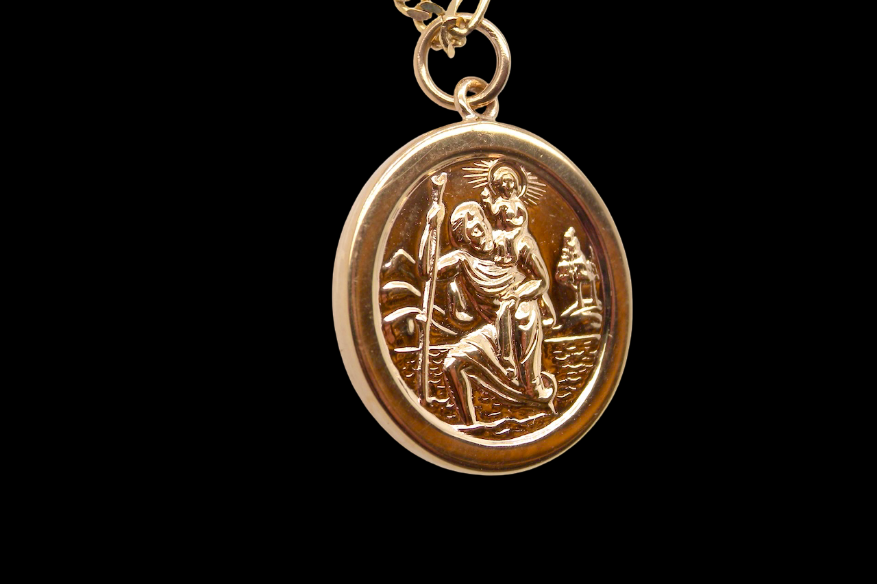 side The Patron Saint for Travellers, a gold St Christopher medallion. 