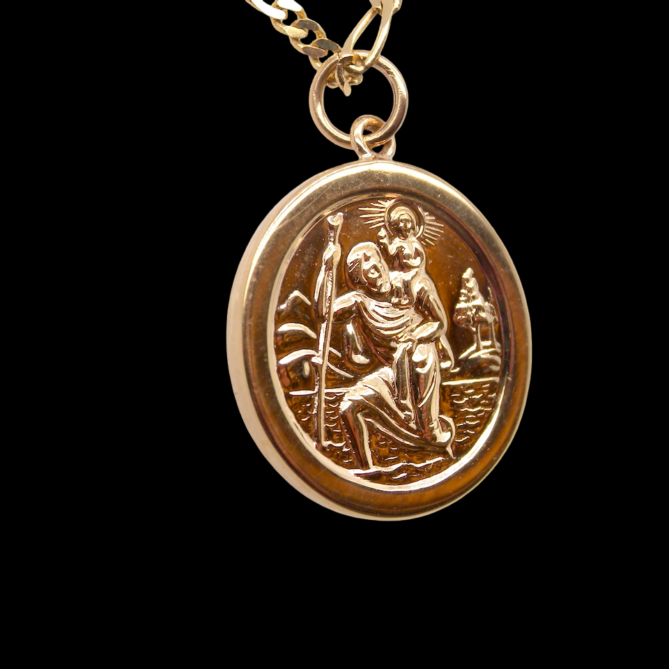 side The Patron Saint for Travellers, a gold St Christopher medallion. 