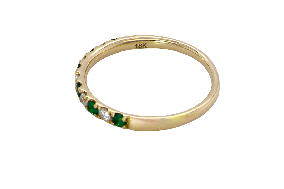 side This ring is set with six bright green emeralds, each 2mm, (est 0.25 carats) and five 2mm brilliant cut white diamonds.