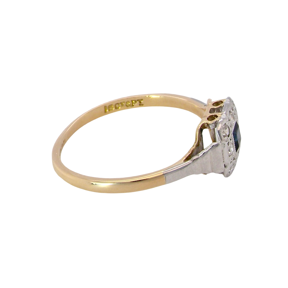 side antique cluster ring. Features a small square sapphire