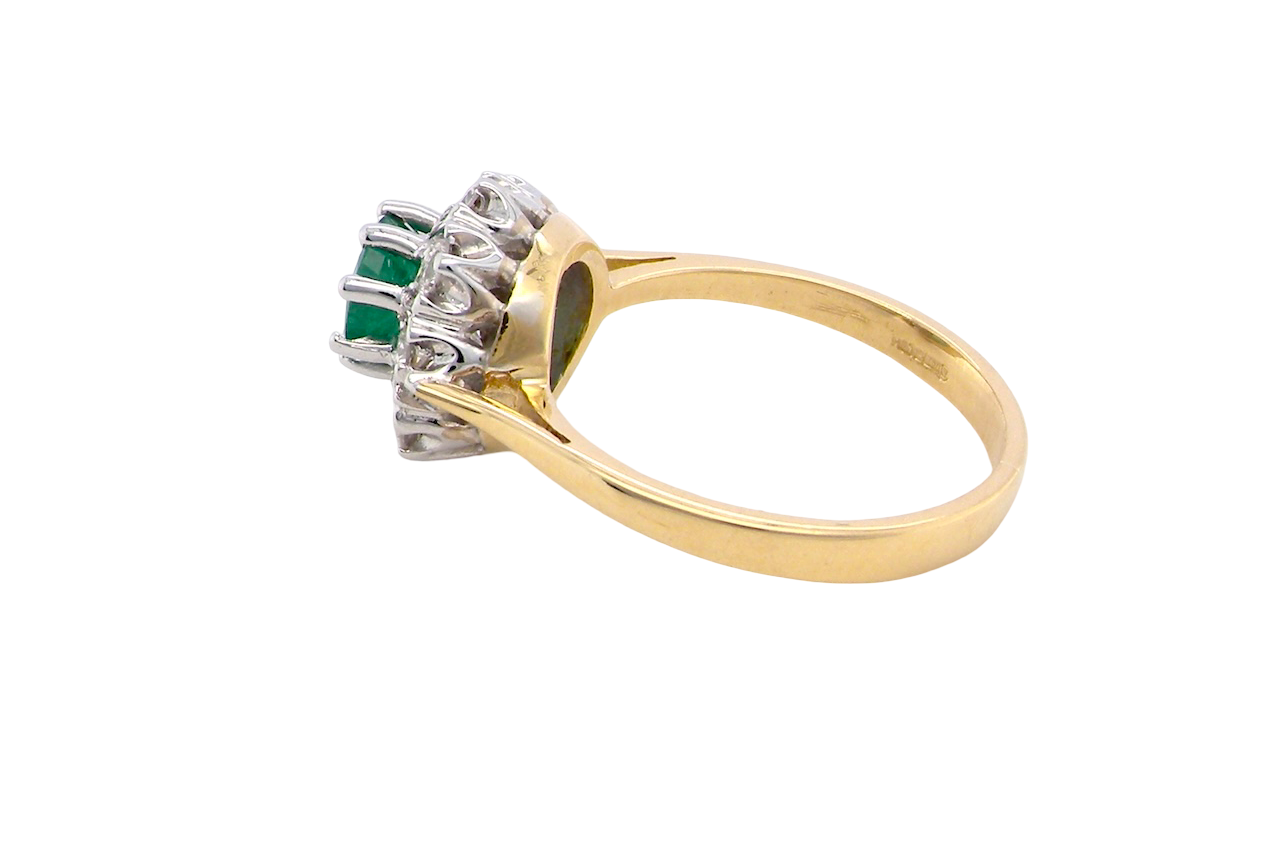 side beautiful cluster ring featuring a 6mm round emerald