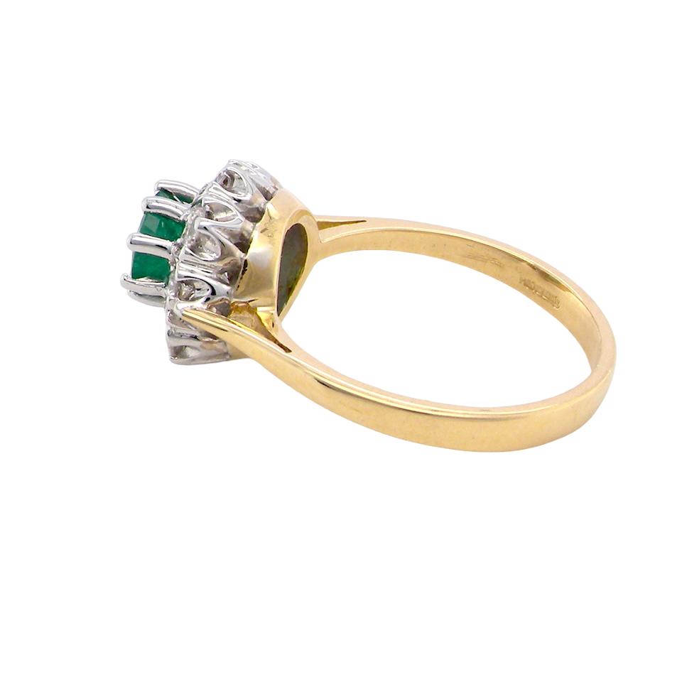 side beautiful cluster ring featuring a 6mm round emerald