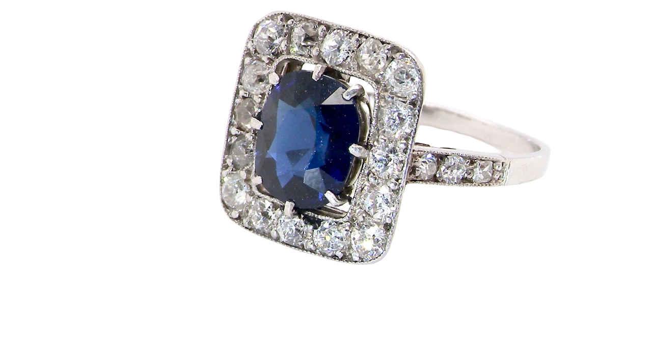 side beautiful original Art Deco cluster ring featuring a rich, dark blue oval-cut sapphire