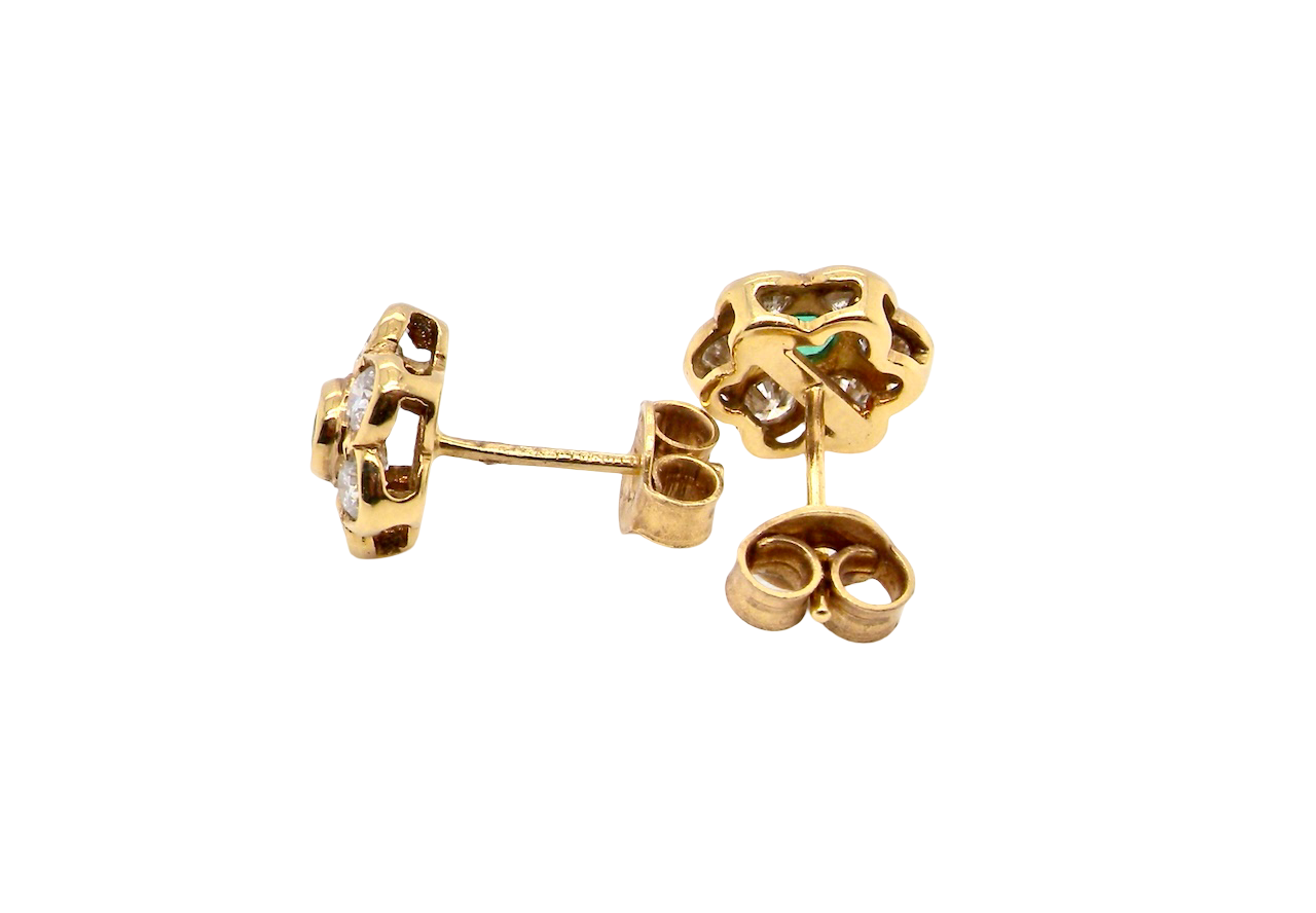 side classic cluster earrings, each featuring a round emerald