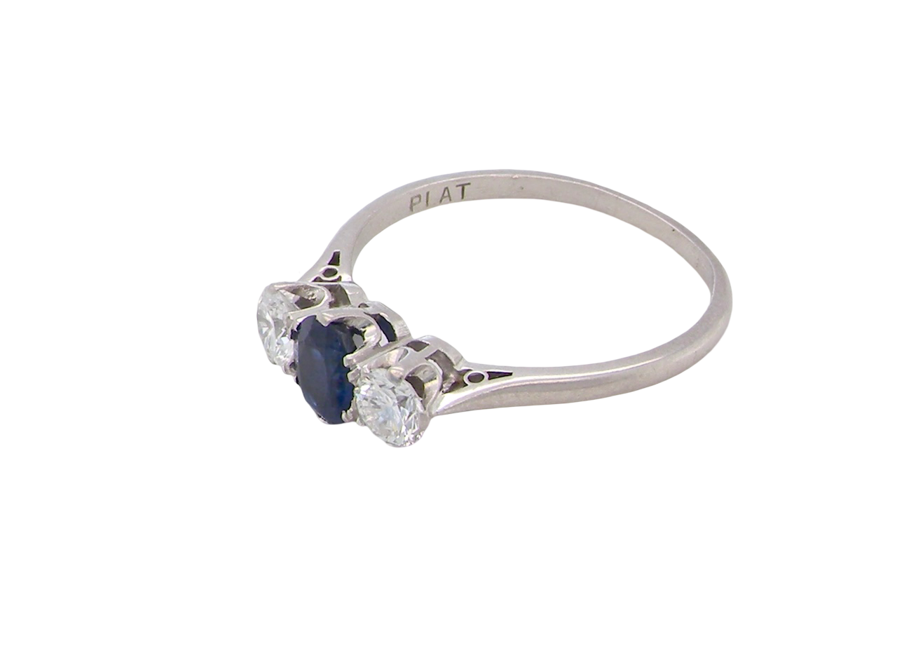 side classic trilogy ring set with an exquisite oval cut sapphire centre stone, hues of deep blue colour and measuring 6x4.2mm (est approx 0.50 carats)