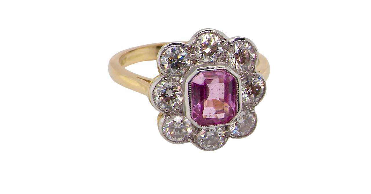 side cluster ring featuring a beautiful cushion-cut pink sapphire
