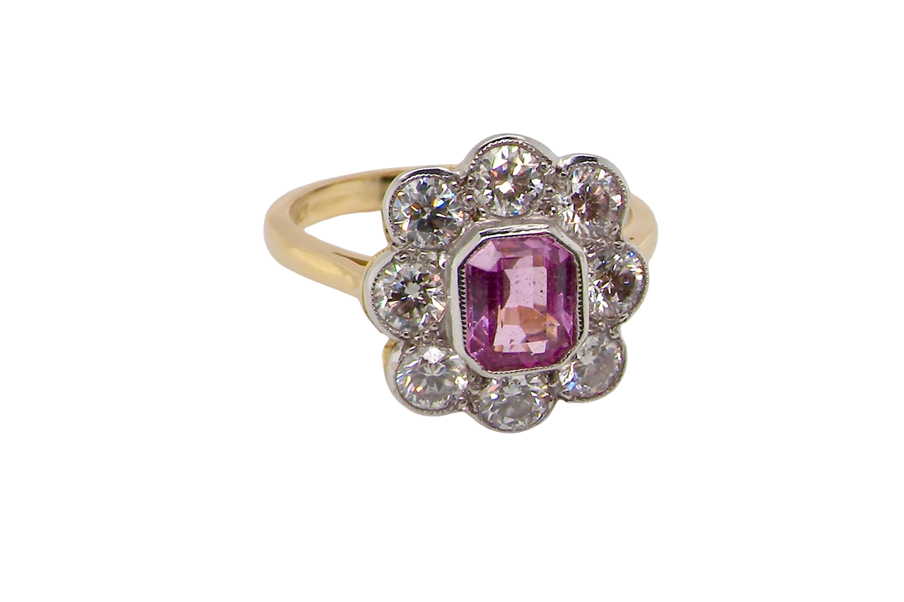 side cluster ring featuring a beautiful cushion-cut pink sapphire