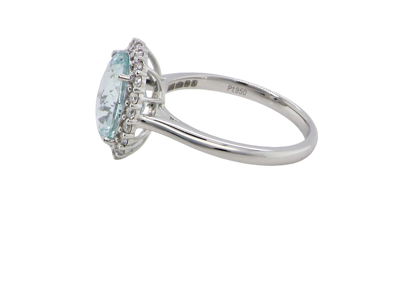 side elegant cluster ring centred on a beautiful oval aquamarine,