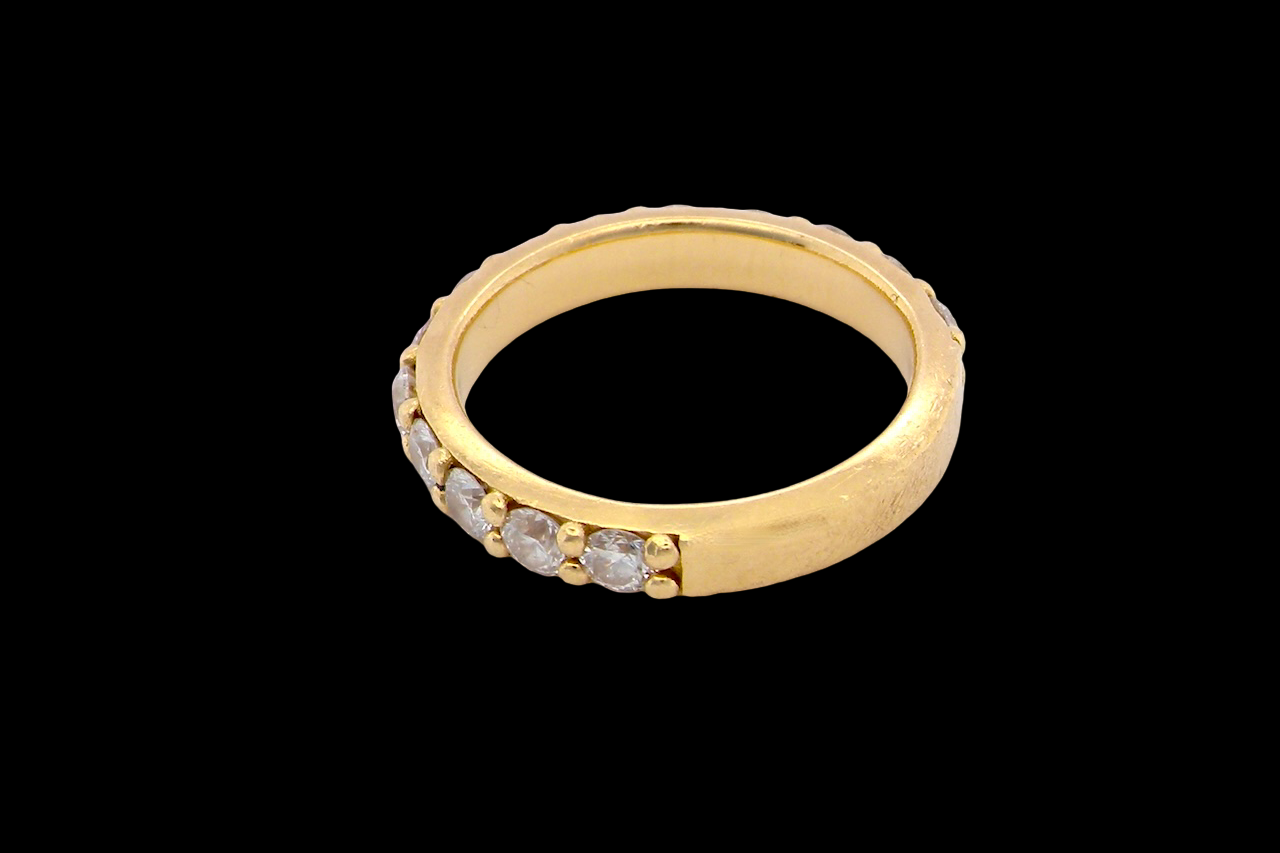 side eternity ring is crafted in 18ct gold and set with fourteen round brilliant-cut white diamonds.