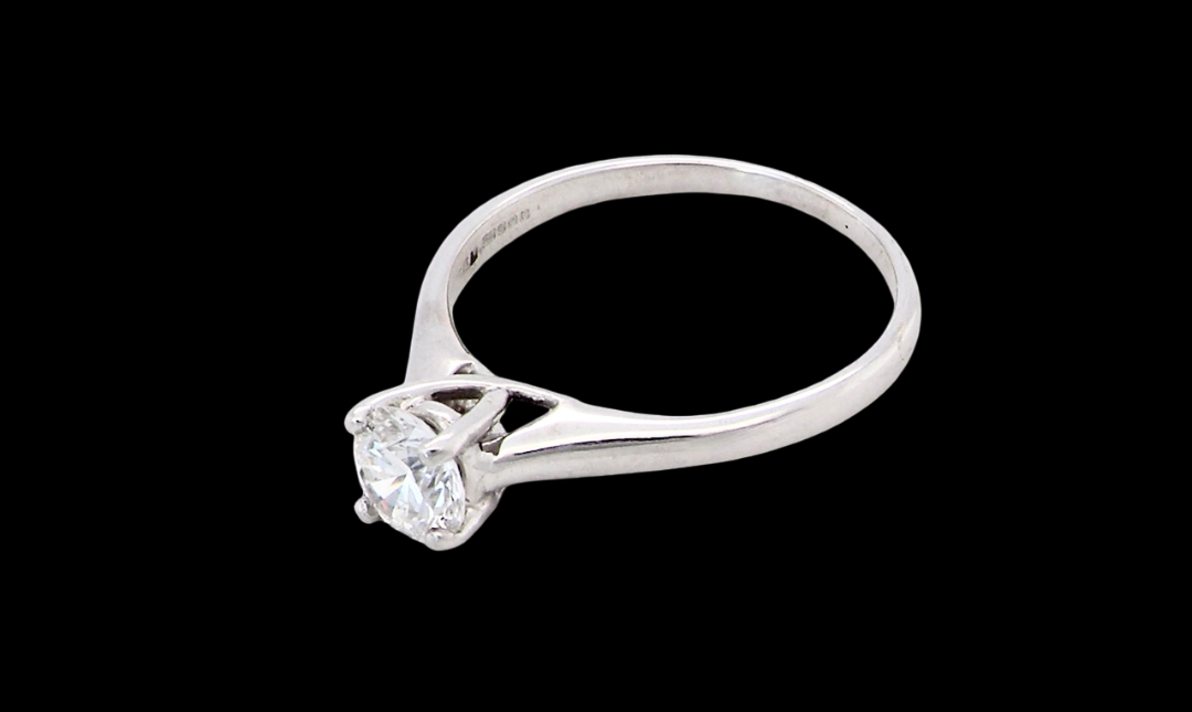 side solitaire ring containing a fine modern brilliant cut white diamond. Measures 5.4mm (.53 carats)
Colour G-h, clarity Si. Modern feature under setting, depth 6.8mm, weight 2.6grams.